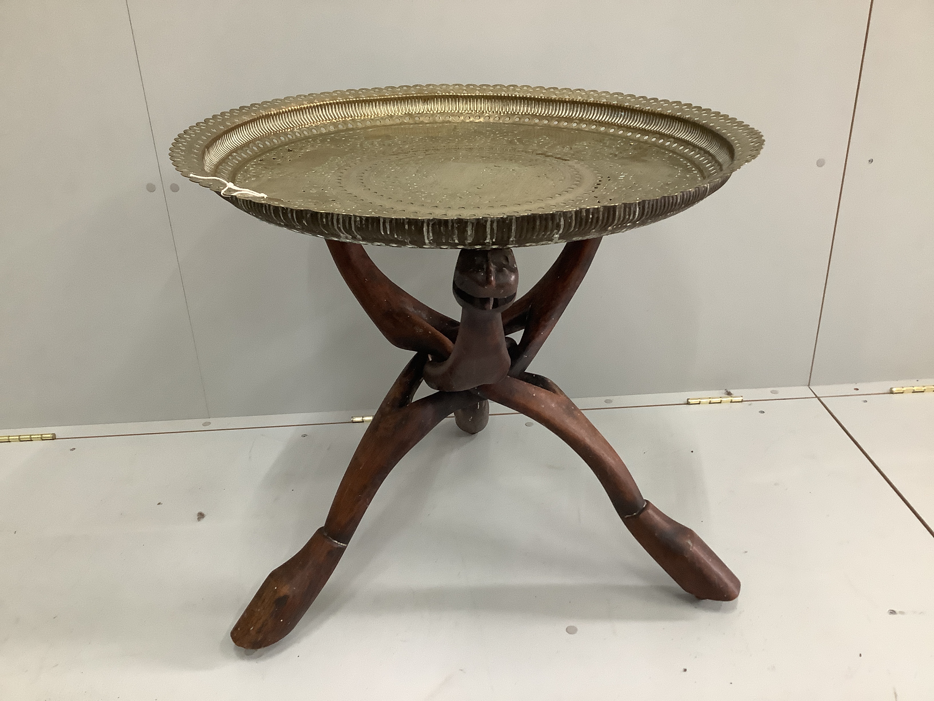 An Indian circular pierced brass tray top occasional table, diameter 69cm, height 65cm